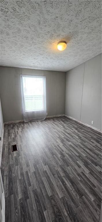 2251 Nemaha Rd, Cummings, KS 66016 - spare room featuring dark wood-style floors and a textured ceiling