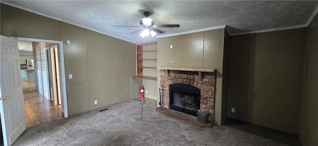 2251 Nemaha Rd, Cummings, KS 66016 - unfurnished living room featuring ornamental molding, ceiling fan, a fireplace, a textured ceiling, and carpet