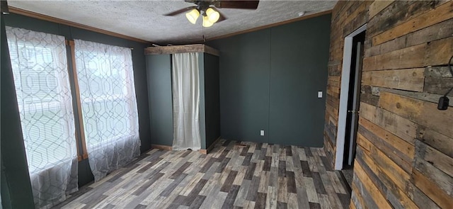 2251 Nemaha Rd, Cummings, KS 66016 - empty room featuring healthy amount of natural light, a ceiling fan, a textured ceiling, wood finished floors, and crown molding