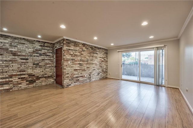5008 Baltimore Ave Unit 102, Kansas City, MO 64112 - unfurnished room featuring ornamental molding, wood finished floors, recessed lighting, and brick wall