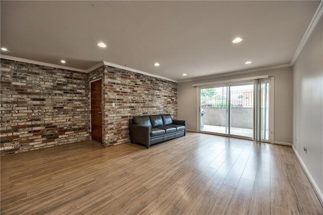 5008 Baltimore Ave Unit 102, Kansas City, MO 64112 - unfurnished living room featuring recessed lighting, wood finished floors, ornamental molding, and brick wall