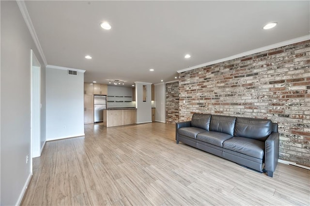 5008 Baltimore Ave Unit 102, Kansas City, MO 64112 - living room with ornamental molding, recessed lighting, light wood-type flooring, and brick wall