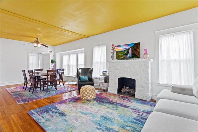 111 E Ruby Ave, Independence, MO 64050 - living room with wood finished floors, a fireplace, and a ceiling fan