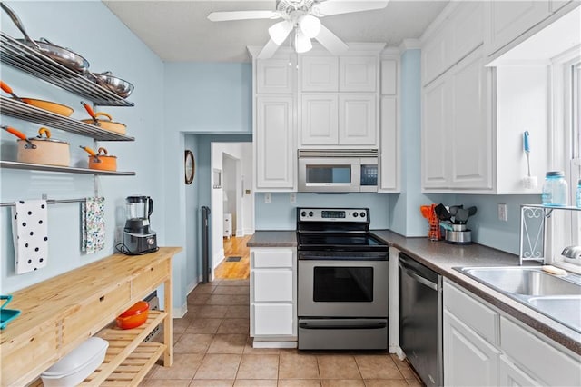 111 E Ruby Ave, Independence, MO 64050 - kitchen featuring stainless steel appliances, white cabinets, light tile patterned flooring, ceiling fan, and open shelves