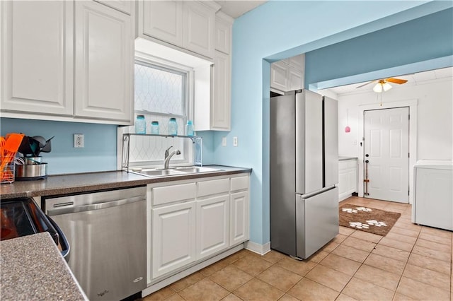 111 E Ruby Ave, Independence, MO 64050 - kitchen featuring stainless steel appliances, washer / dryer, white cabinets, a ceiling fan, and light tile patterned floors