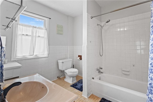111 E Ruby Ave, Independence, MO 64050 - full bathroom with vanity, shower / tub combo, wainscoting, tile walls, and tile patterned flooring