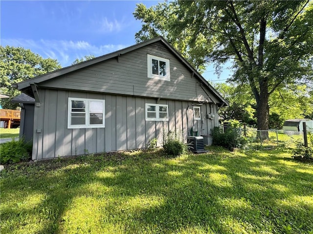 110 W 7th St, Knob Noster, MO 65336 - view of home's exterior with board and batten siding and a central air condition unit
