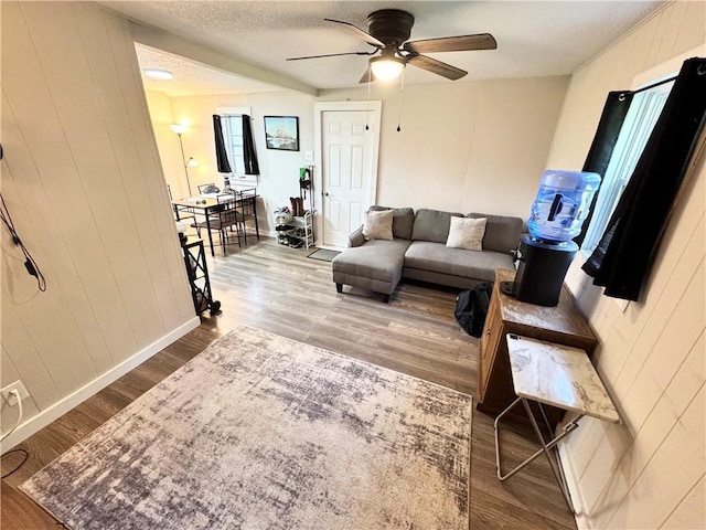110 W 7th St, Knob Noster, MO 65336 - living room with wood finished floors, ceiling fan, and a textured ceiling