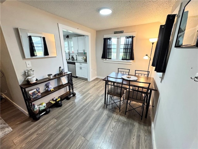 110 W 7th St, Knob Noster, MO 65336 - dining room with wood finished floors and a textured ceiling