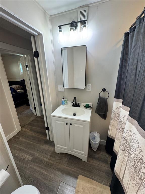 110 W 7th St, Knob Noster, MO 65336 - full bathroom with wood finished floors and vanity