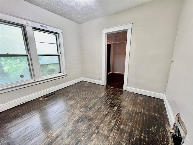 522 S 2nd St, Independence, KS 67301 - spare room featuring wood-type flooring and a textured ceiling