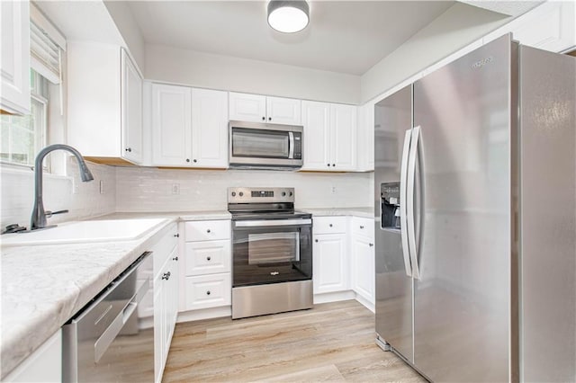 4612 Whispering Winds Dr Unit B, Lees Summit, MO 64064 - kitchen featuring appliances with stainless steel finishes, light countertops, and white cabinetry
