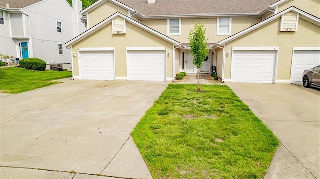 4612 Whispering Winds Dr Unit B, Lees Summit, MO 64064 - view of front of house with concrete driveway, a garage, a front yard, and stucco siding