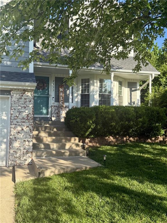 2433 Post Oak Rd, Olathe, KS 66061 - doorway to property with a lawn and roof with shingles