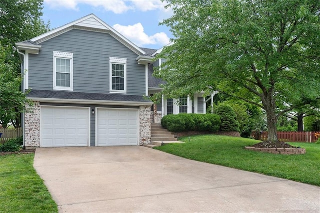 2433 Post Oak Rd, Olathe, KS 66061 - view of front facade with driveway, an attached garage, and a shingled roof