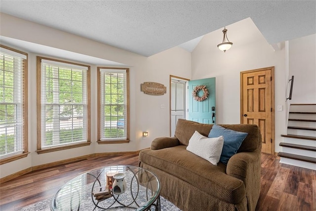 2433 Post Oak Rd, Olathe, KS 66061 - living room with lofted ceiling, healthy amount of natural light, wood finished floors, stairway, and a textured ceiling