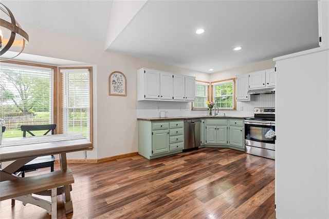 2433 Post Oak Rd, Olathe, KS 66061 - kitchen featuring appliances with stainless steel finishes, under cabinet range hood, dark wood-style floors, green cabinetry, and recessed lighting