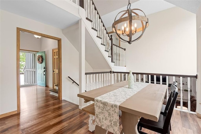 2433 Post Oak Rd, Olathe, KS 66061 - dining room with wood finished floors, a chandelier, and stairway