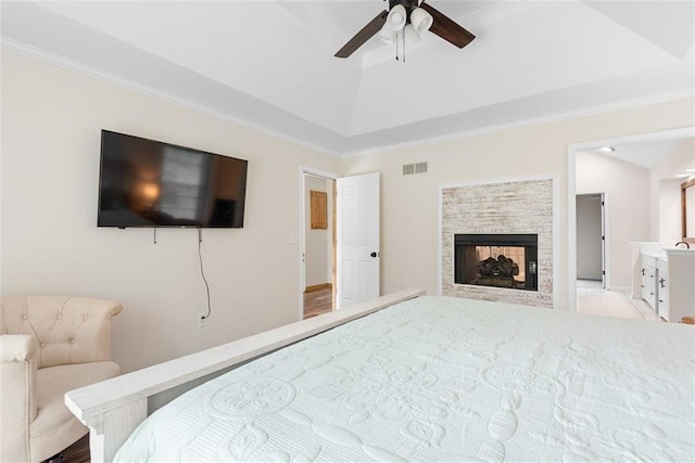 2433 Post Oak Rd, Olathe, KS 66061 - bedroom featuring ornamental molding, a fireplace, a raised ceiling, and a ceiling fan