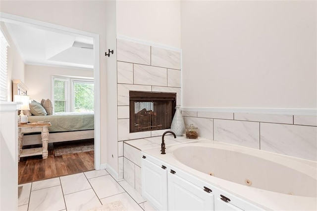 2433 Post Oak Rd, Olathe, KS 66061 - ensuite bathroom with a tub with jets, a fireplace, and ornamental molding