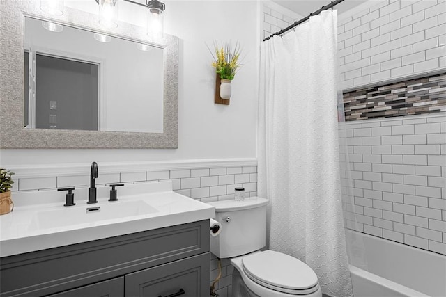 2433 Post Oak Rd, Olathe, KS 66061 - full bathroom with vanity, shower / bath combo, wainscoting, and tile walls