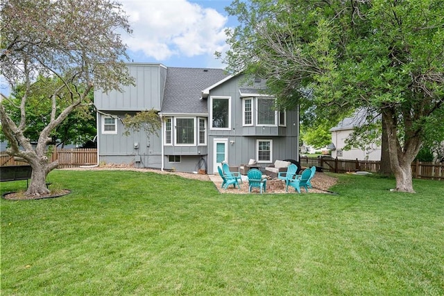 2433 Post Oak Rd, Olathe, KS 66061 - back of property featuring a fenced backyard, board and batten siding, and a shingled roof