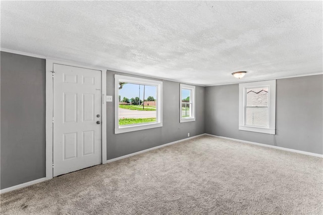 1202 E 23rd St S, Independence, MO 64055 - foyer entrance featuring a textured ceiling and carpet