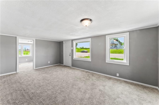 1202 E 23rd St S, Independence, MO 64055 - carpeted empty room featuring a textured ceiling and baseboards