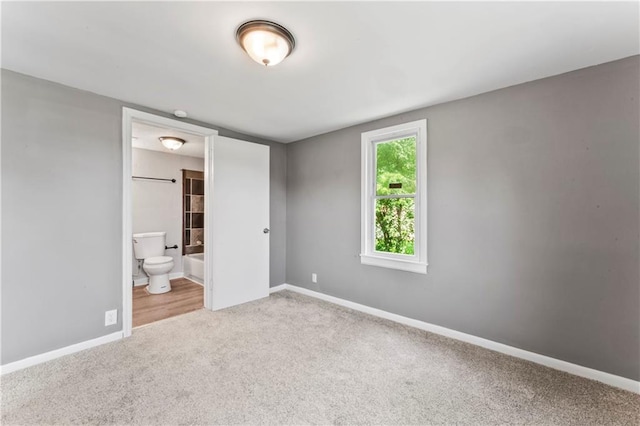 1202 E 23rd St S, Independence, MO 64055 - unfurnished bedroom featuring carpet floors and ensuite bathroom
