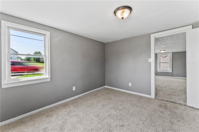 1202 E 23rd St S, Independence, MO 64055 - carpeted spare room featuring baseboards