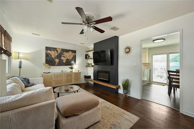 6217 Glenwood St, Mission, KS 66202 - living room with a fireplace, wood finished floors, and a ceiling fan