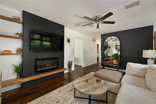 6217 Glenwood St, Mission, KS 66202 - living room featuring a ceiling fan, wood finished floors, a fireplace, and arched walkways