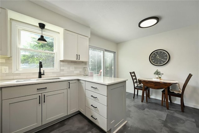 6217 Glenwood St, Mission, KS 66202 - kitchen with backsplash, healthy amount of natural light, and light countertops
