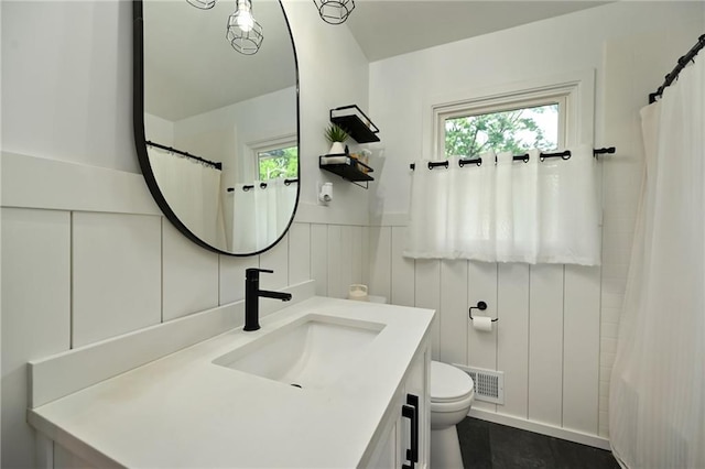 6217 Glenwood St, Mission, KS 66202 - bathroom with vanity, plenty of natural light, a wainscoted wall, a shower with curtain, and a decorative wall