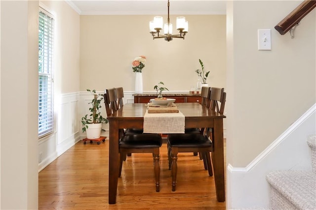 5217 Birch St, Roeland Park, KS 66205 - dining room featuring a chandelier, light wood finished floors, crown molding, and stairs