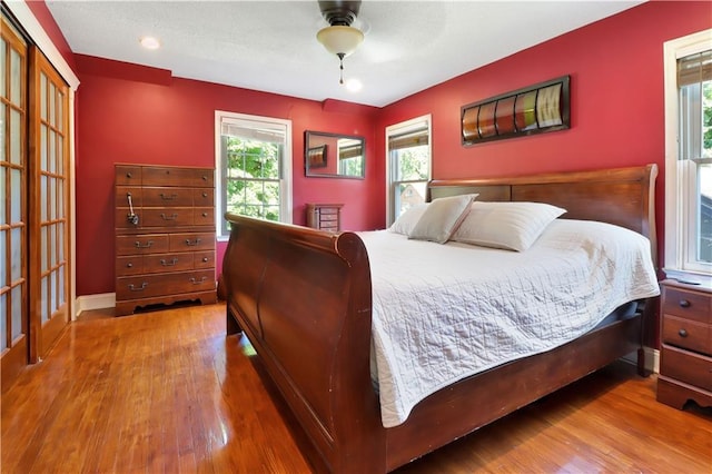 5217 Birch St, Roeland Park, KS 66205 - bedroom with multiple windows, wood finished floors, and a ceiling fan