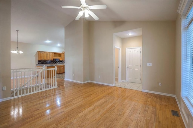 15730 S Brentwood St Unit 2602, Olathe, KS 66062 - unfurnished living room featuring light wood-type flooring, a ceiling fan, and vaulted ceiling