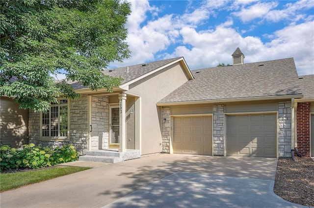 15730 S Brentwood St Unit 2602, Olathe, KS 66062 - view of front of house with stone siding, an attached garage, driveway, roof with shingles, and stucco siding