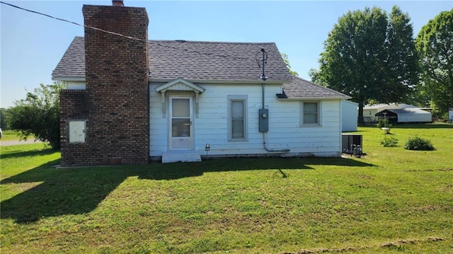 304 N Mckinley St, Weir, KS 66781 - back of house with a chimney, a lawn, entry steps, and a shingled roof