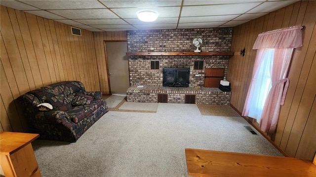 304 N Mckinley St, Weir, KS 66781 - living area with wooden walls, carpet floors, and a paneled ceiling
