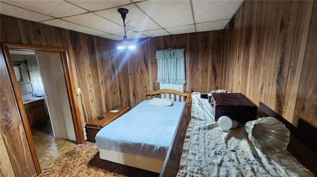304 N Mckinley St, Weir, KS 66781 - bedroom featuring wooden walls and a drop ceiling