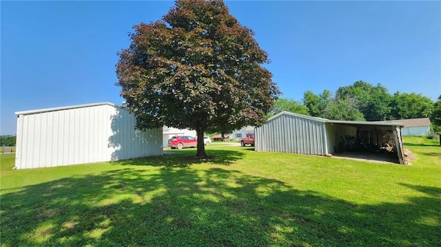 304 N Mckinley St, Weir, KS 66781 - view of grassy yard featuring a pole building, an outbuilding, and a carport