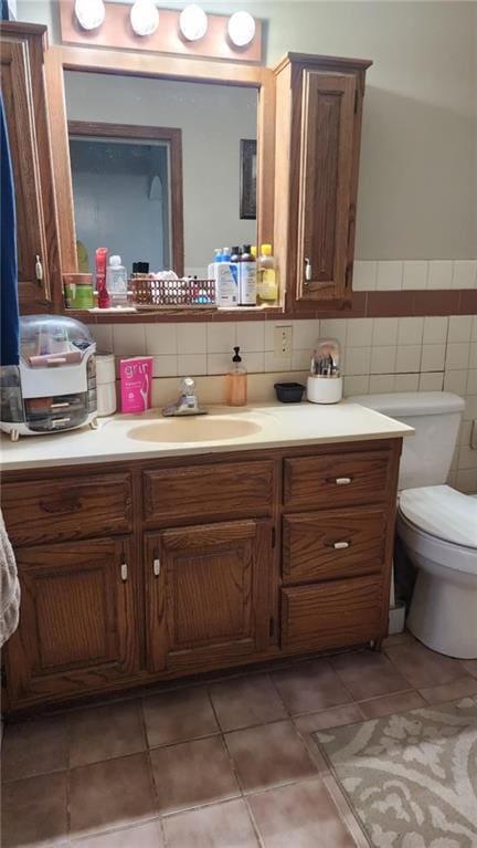 304 N Mckinley St, Weir, KS 66781 - bathroom with vanity, tile patterned flooring, tile walls, and a wainscoted wall