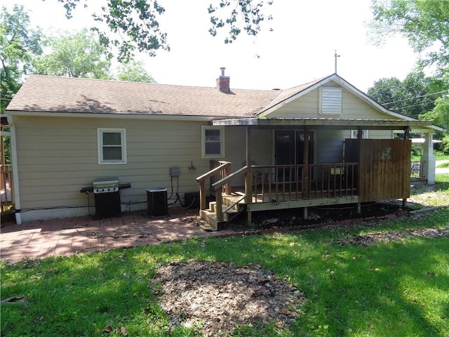 11401 E Scarritt Ave, Sugar Creek, MO 64054 - rear view of property with a lawn, a patio area, roof with shingles, and a chimney
