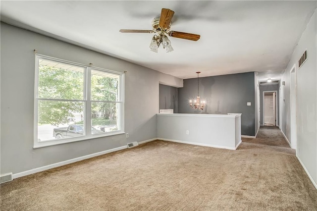 508 NE Shiloh Cir, Blue Springs, MO 64014 - empty room featuring a chandelier, carpet, and ceiling fan