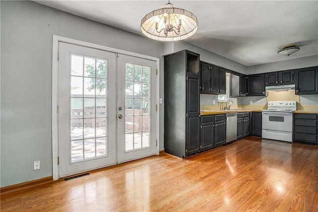 508 NE Shiloh Cir, Blue Springs, MO 64014 - kitchen featuring electric range, under cabinet range hood, stainless steel dishwasher, french doors, and light countertops