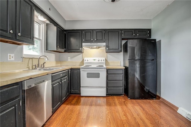 508 NE Shiloh Cir, Blue Springs, MO 64014 - kitchen featuring dishwasher, white electric range oven, freestanding refrigerator, under cabinet range hood, and tasteful backsplash
