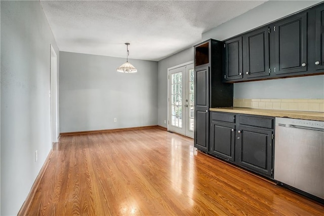 508 NE Shiloh Cir, Blue Springs, MO 64014 - kitchen featuring dishwasher, light wood finished floors, light countertops, hanging light fixtures, and a textured ceiling