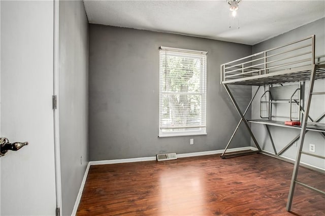 508 NE Shiloh Cir, Blue Springs, MO 64014 - unfurnished bedroom with wood finished floors and baseboards