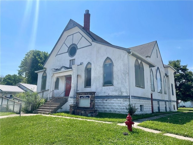 130 W 2nd St, Clearmont, MO 64431 - tudor home featuring a front yard, stucco siding, and a chimney